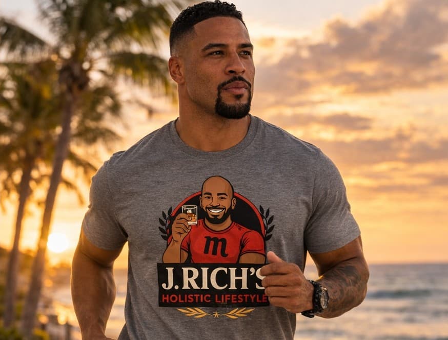 Man running on the beach at sunset in a grey J. Rich's Holistic Lifestyle tee